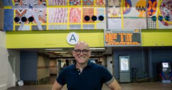 Tim Doud with his Art at Amtrak mural “A Great Public Work”