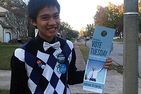 Marjun holding a voter registration flyer
