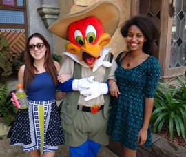 Students posing with a character