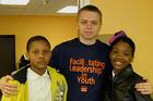 Joshua with the two students he mentored.