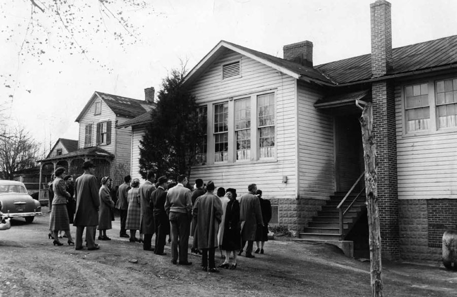 A crowd outside a house