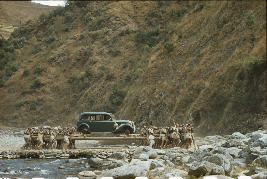 Sixty porters carry a Mercedes from Nepal to Calcutta.