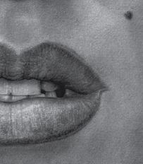 Close-up of lips, teech, and mole suggesting Marilyn Monroe.