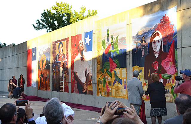 Chilean President in front of mural with audience at AU Museum