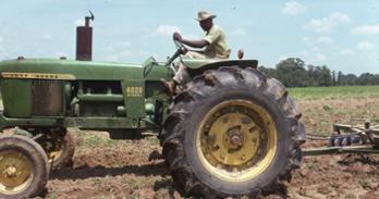 Vintage photo of man on tractor, Photo courtesy of the FSC/LAF Black farmer archives