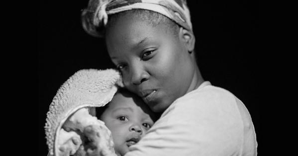 Mother holding child close, credit Andrae Ricketts