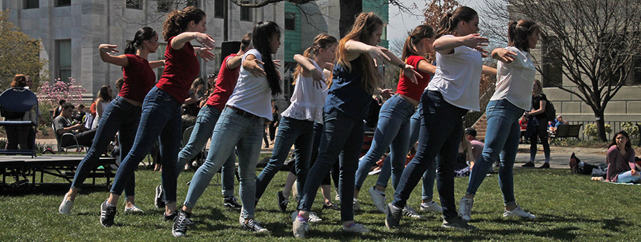 Dancers perform on the lawn in front of Mary Graydon Center