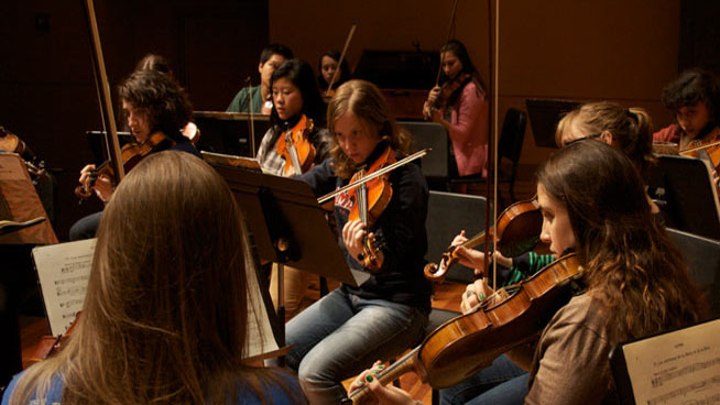 Students practice the violin.