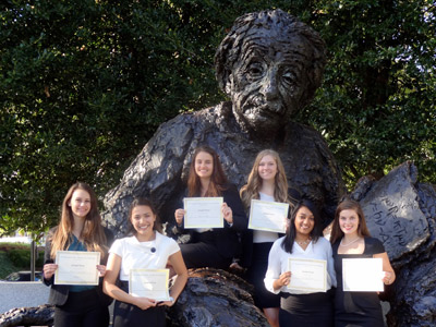 Students stand near statue of Einstein