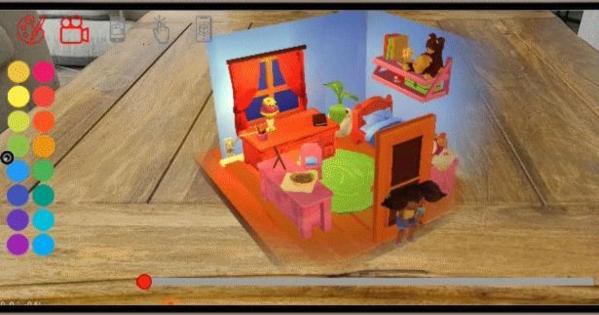 A hologram of a children’s book story is superimposed onto a wooden table. The story’s hologram depicts a room of a young girl, who is standing by the door frame.