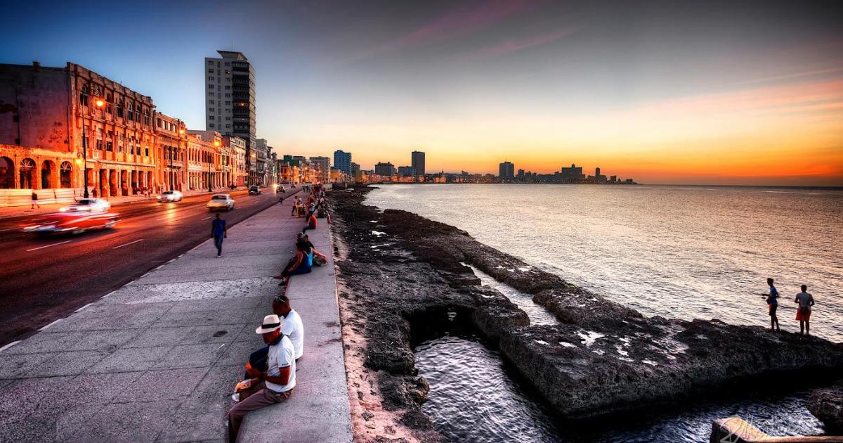 Image of the Malecón with a silhouette of Havana in the background