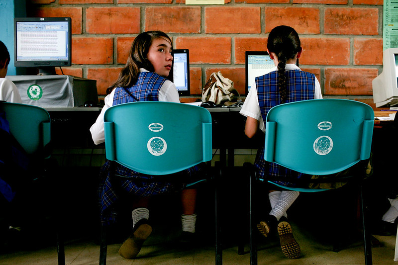 Two young girls on computers in class