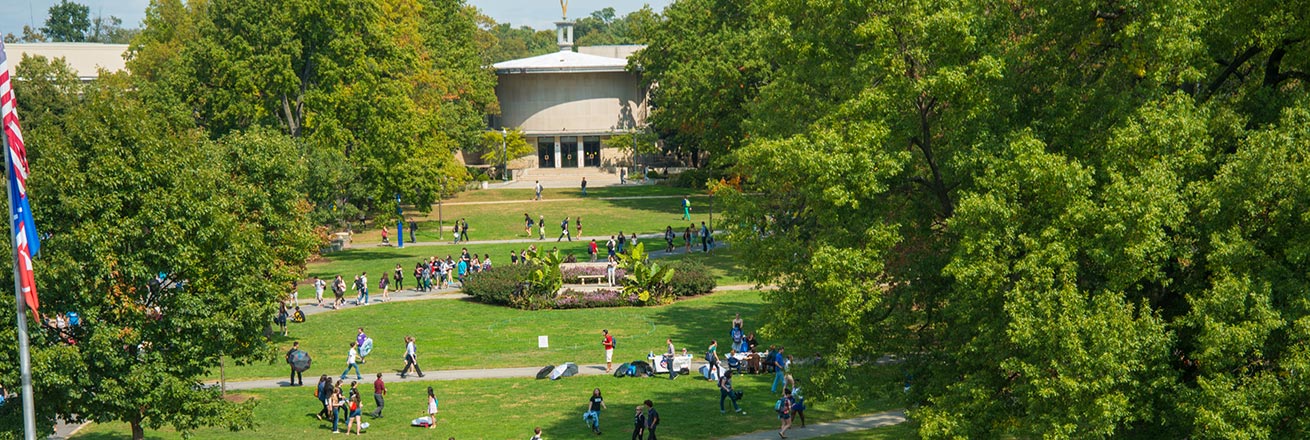 Students on the quad in summer, with the Kay Spiritual Life Center in the background