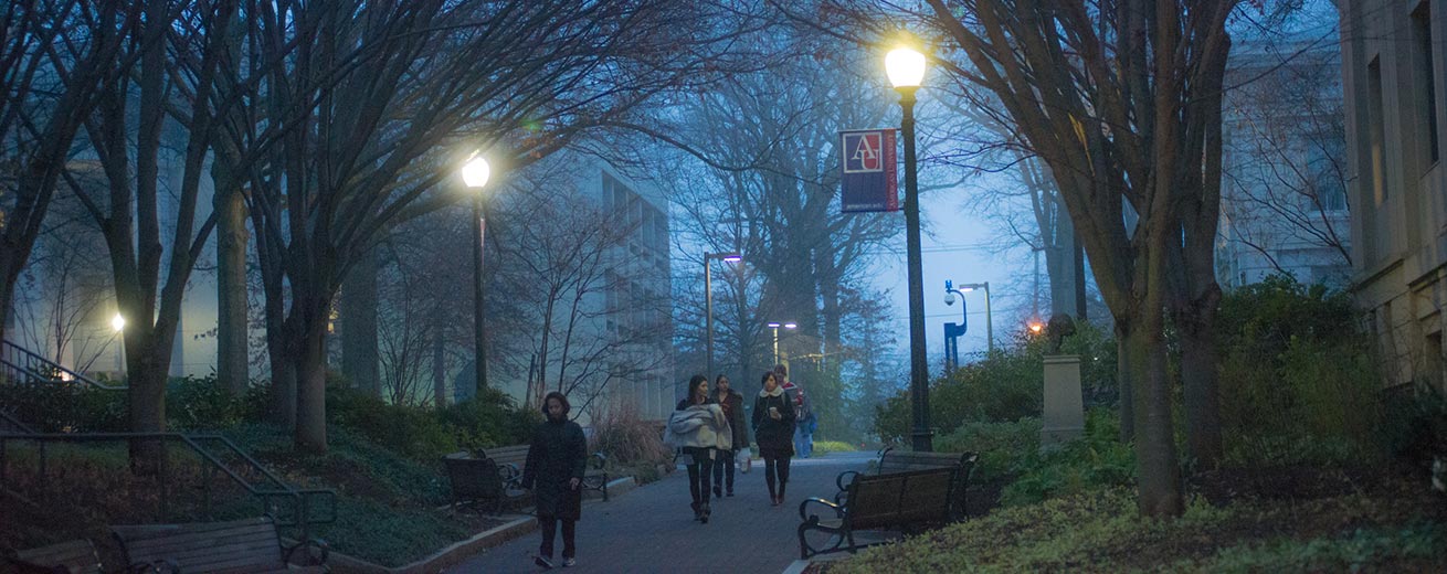 Students walking on campus at dusk