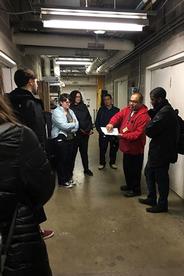 An Energy and Engineering staff member shows students the energy efficiency measures in the Katzen mechanical room