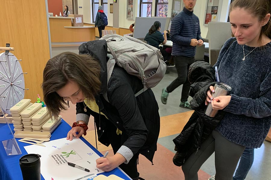 Students signing a pledge to not use single-use plastics