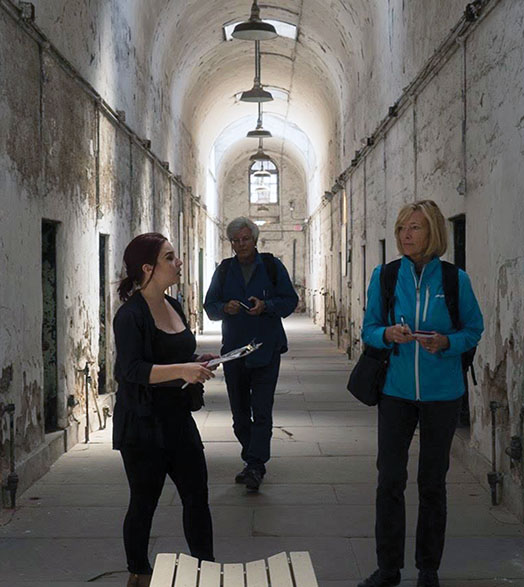 Maggie Stogner and two others tour an old prison