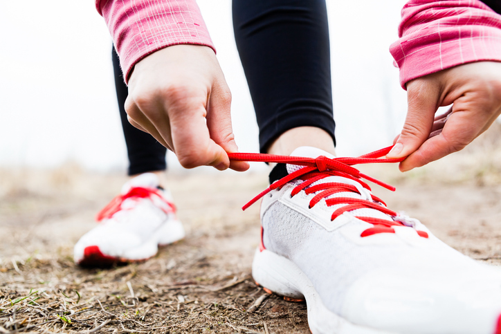 Runner tying shoe laces