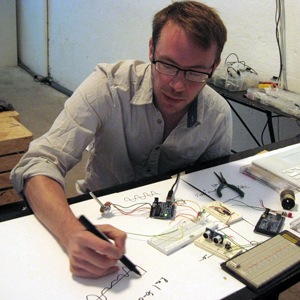 Professor Andrew Holtin sitting and drawing
