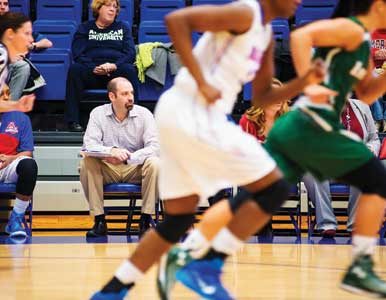 Writer Mike Unger on the bench of the AU women's basketball team