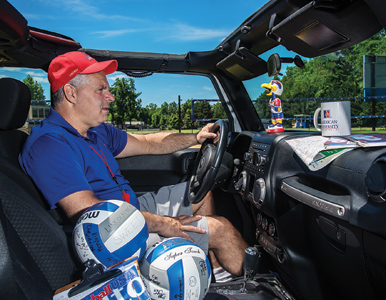 AU volletball coach Barry Goldberg sits behind the wheel of his Jeep