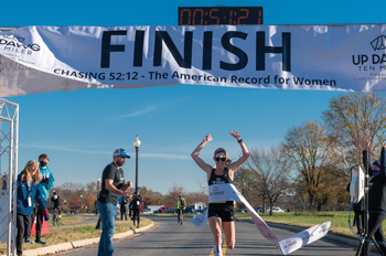 Keira D'Amato crosses the finish line of the Up Dawg Ten Miler in Anacostia Park