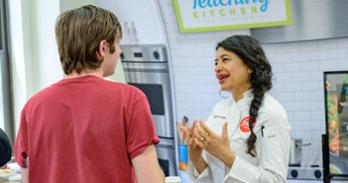 Celebrity chef Bal Arneson speaks with an AU student on April 9. Photo by Jeff Watts.