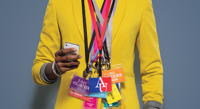 Woman in yellow jacket with lots of different organization ID badges around her neck
