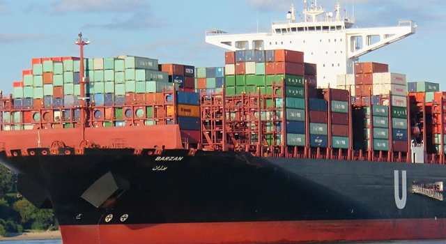 freight ship packed with stacked shipping containers