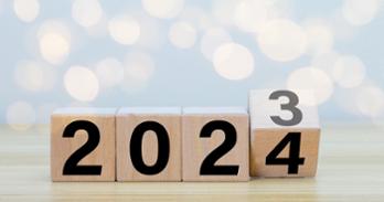Four wooden blocks that spell 2023, with the number three changing to four