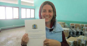 SIS alumna Robin Gary holds a copy of the draft Somalia Constitution