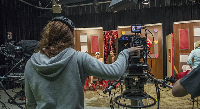 A female student directs during a TV production class
