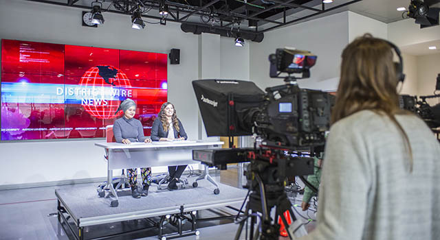 Two student anchors during filming of District Wire news show
