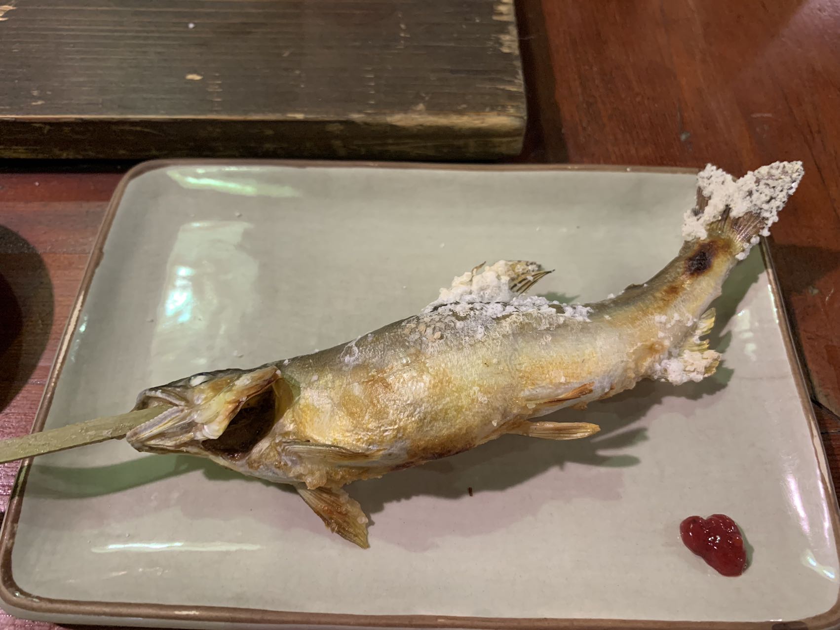 The salt-grilled sweetfish, ayu no shioyaki, are skewered on a curve to make them appear as though they are still swimming against the current.