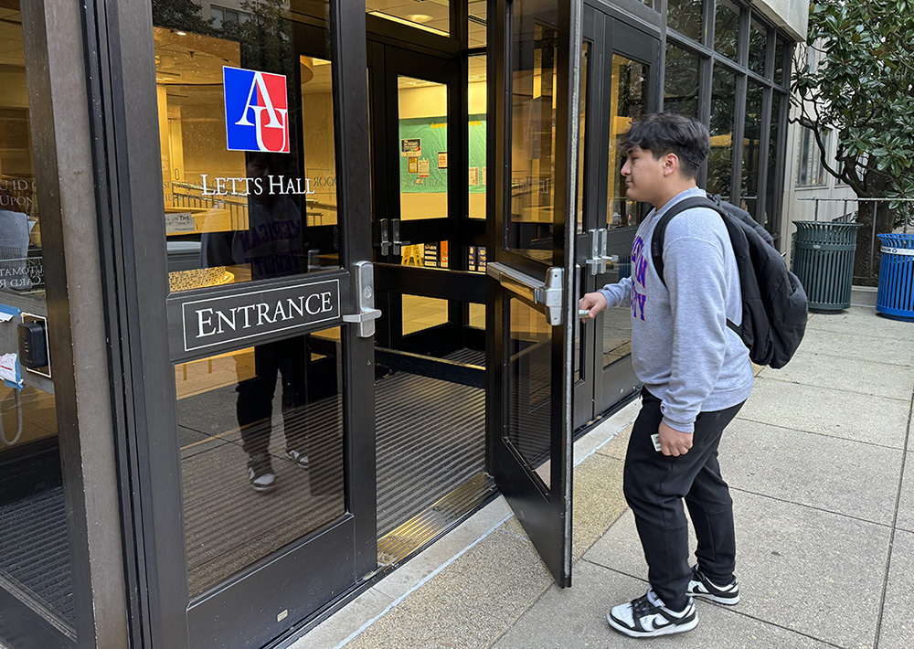 Luis Paredes opens the door to his residence hall, Letts Hall