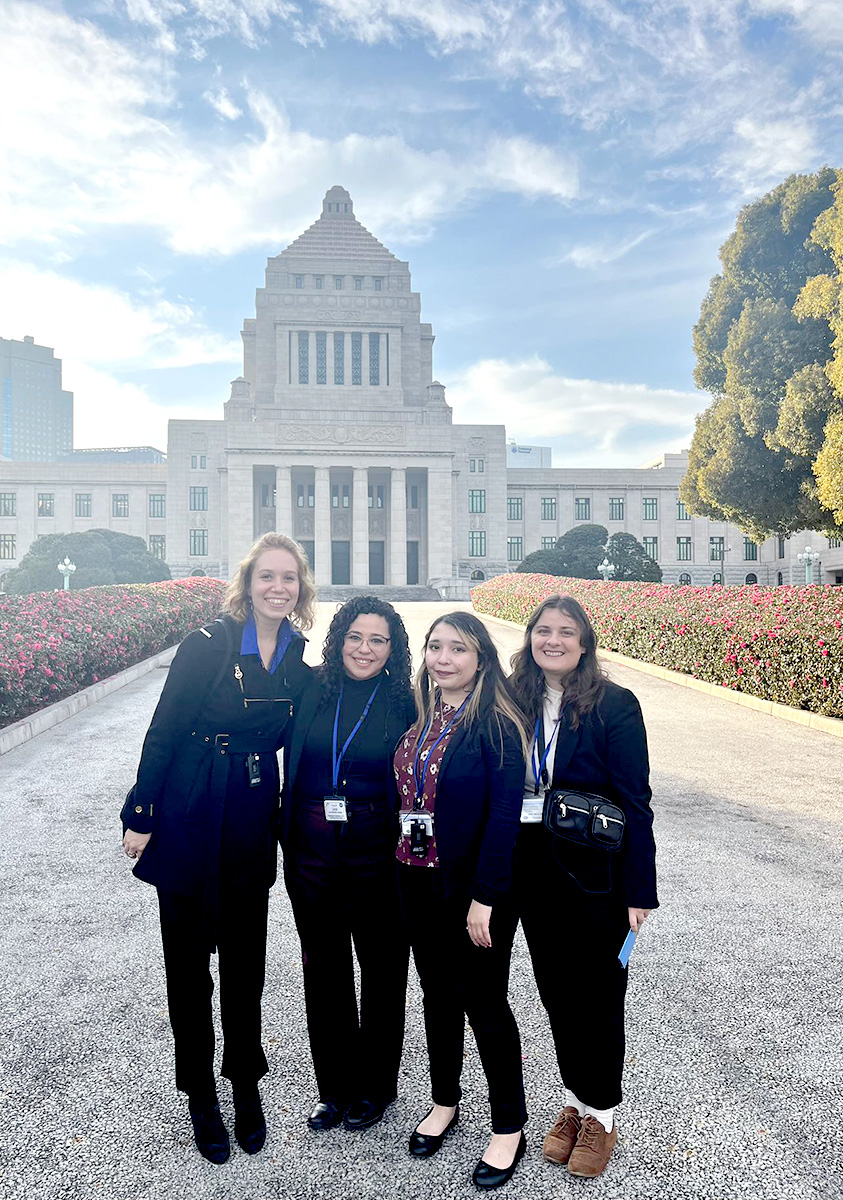 Ansilta De Luca (far left) and Maddy Crawford (far right) in front of the Ministry of Foreign Affairs in Tokyo.