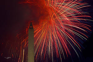 Fireworks erupt behind the Washington Monument at Night (Kevin Sutherland, 2013)