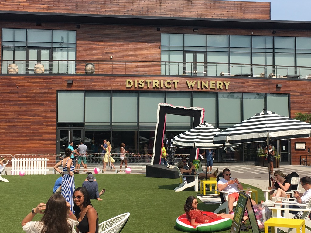 District Winery's front facade with people seated in patio.