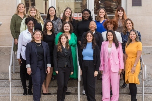 16 women graduates of welead standing outside on steps