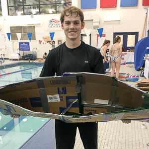 Washington Semester Program student Wes Nichols competing in a boat building race at the American University Wilson Aquatic Center