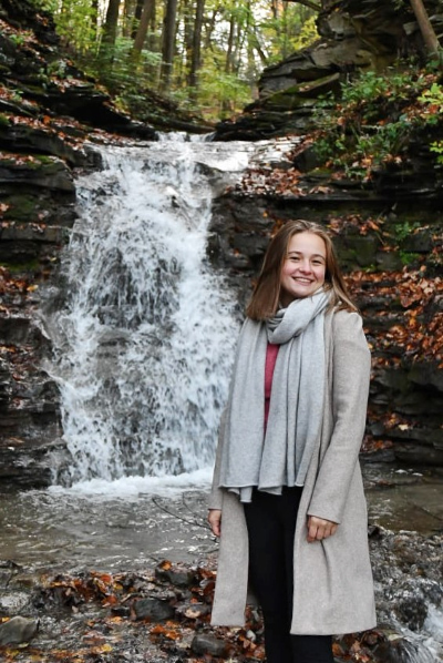 Emily standing in front of a waterfall