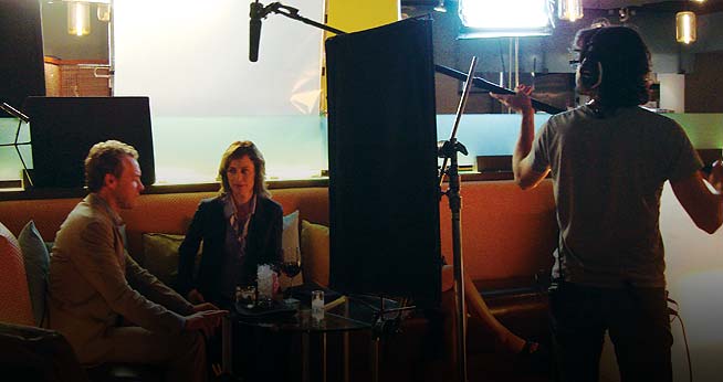 Student operates boom pole for Beyond the Beltway film