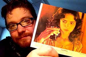Kyle Brannon with a lobby card from the 1977 film Suspiria. It was a gift from a student in his European cinema class. 