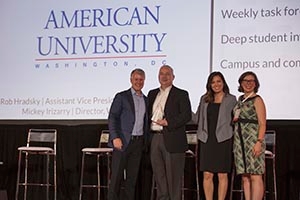 Robert Hradsky and Mickey Irizarry (middle two) accept the EVERFI award on AU's behalf.