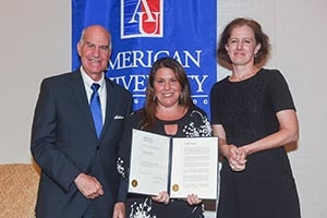 SPA Professor Jennifer Lawless, center, displays a copy of her American University award.