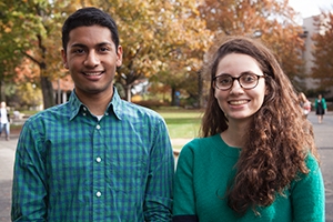 Roshan Thomas and Rim Filali on the campus quad, with fall foliage in the background.