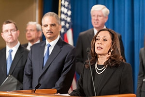 Senator Kamala Harris, right, flanked by former Attorney General Eric Holder and others.