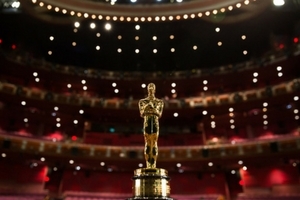 An Academy Award against the backdrop of a theater and theater lights
