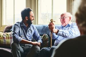 Doctor speaking with elderly man.