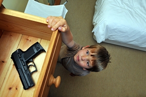 Young child (4-6) reaching for a handgun